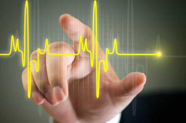 human hand touching a heart rate graph bigsun